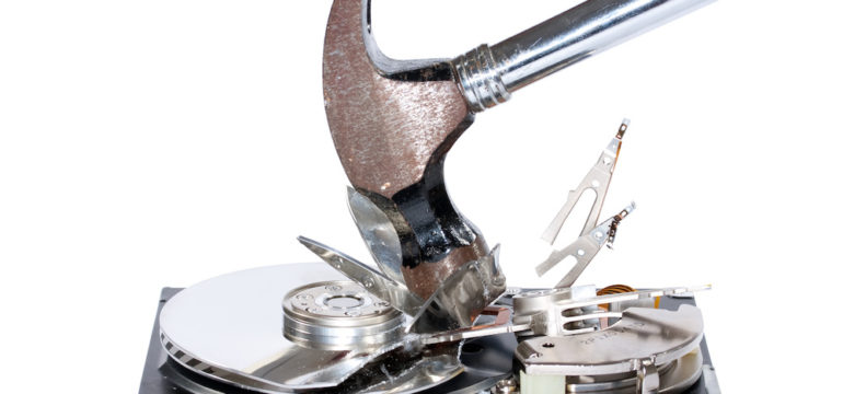 A computer hard drive being destroyed with a hammer for disposing of a computer.