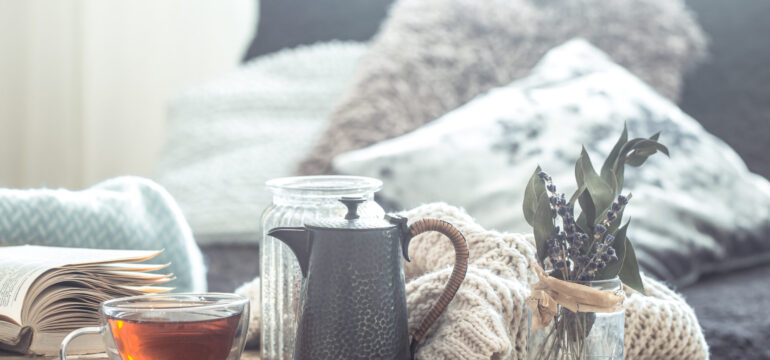 Still life details of home interior on a wooden table with a Cup of tea