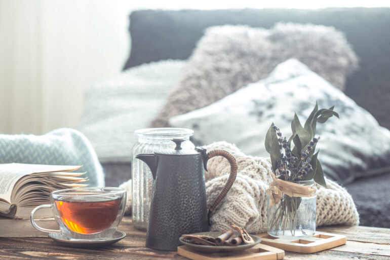 Still life details of home interior on a wooden table with a Cup of tea