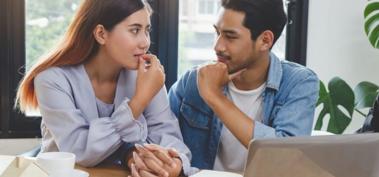 New home buyer couple showing the concept of discussing the subject of financing your first home.