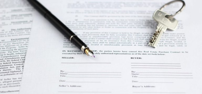 Sales contract for backup offer for real estate, with a gold-nibbed fountain pen and house keys.
