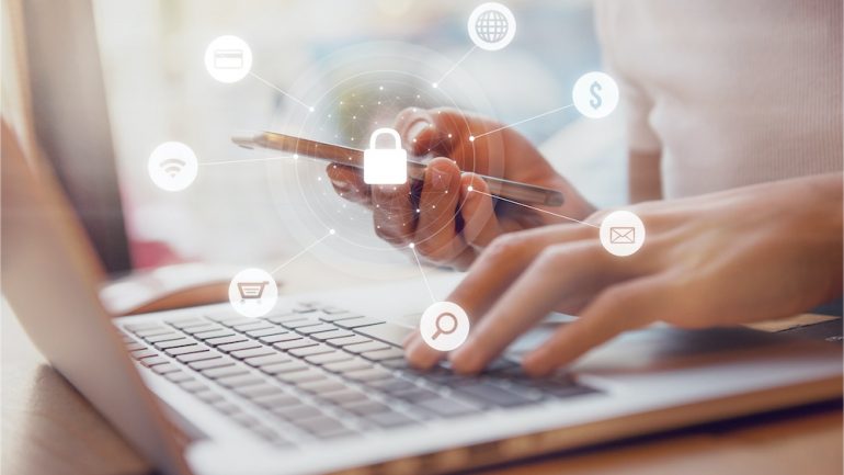 Woman using smartphone and laptop with icon graphic of security network representing protecting herself from online shopping scams.