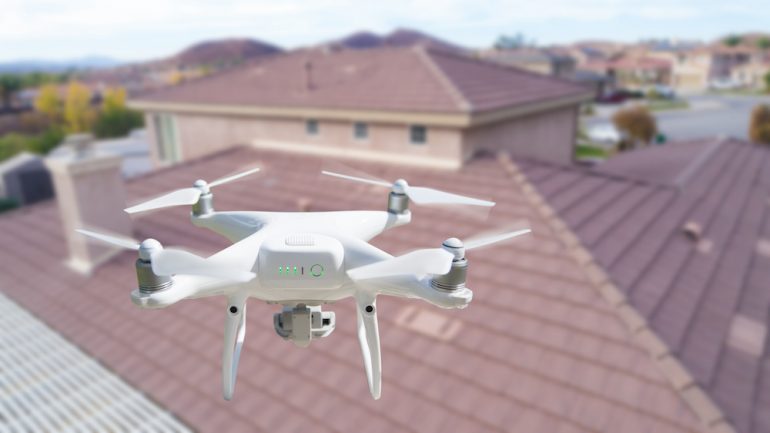 Drone In the air over a house Inspecting the roof.