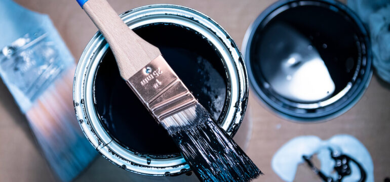 Blue paint spill on a wood floor. Concept of how to remove paint from finished wood.