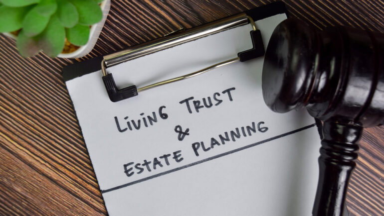 Living Trust and estate planning documents on a wooden table with a judge's gavel.